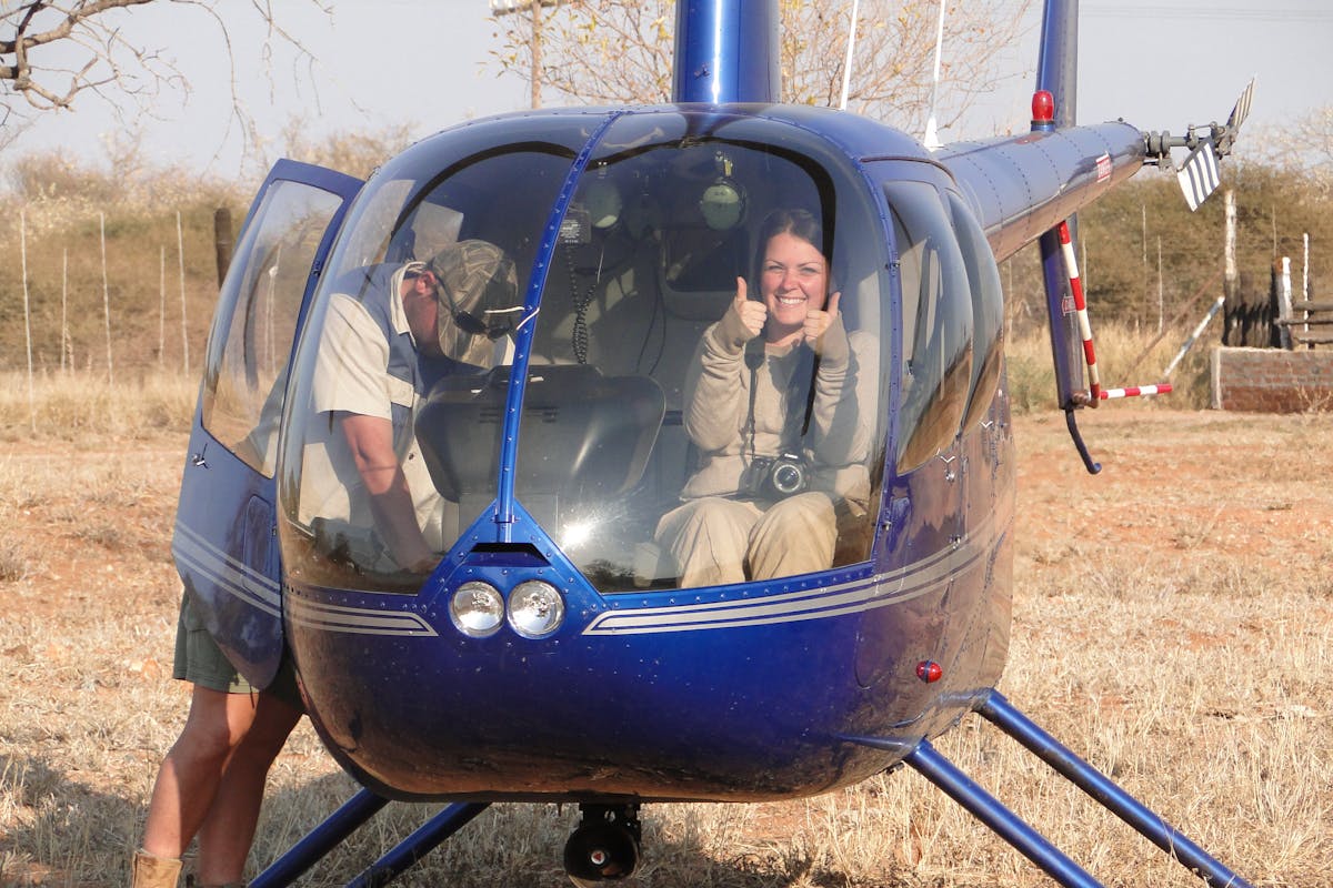 ACE volunteer posing in helicopter