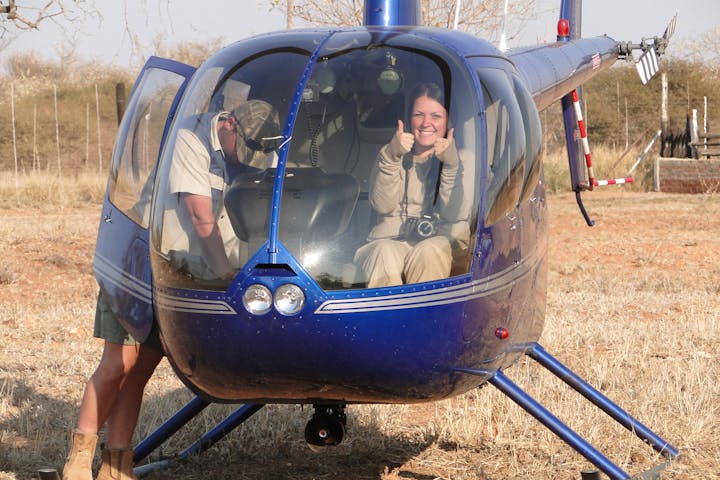 ACE volunteer posing in helicopter