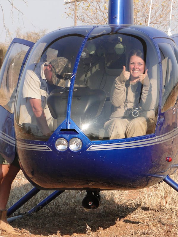 ACE volunteer posing in helicopter