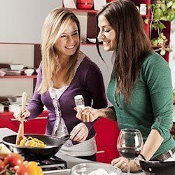Two women cooking together in a kitchen
