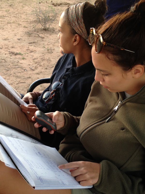 Two students monitoring animals