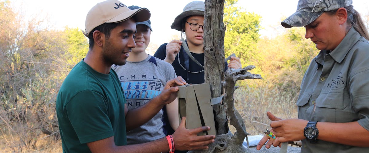 Group of ACE students from a school fitting a camera trap