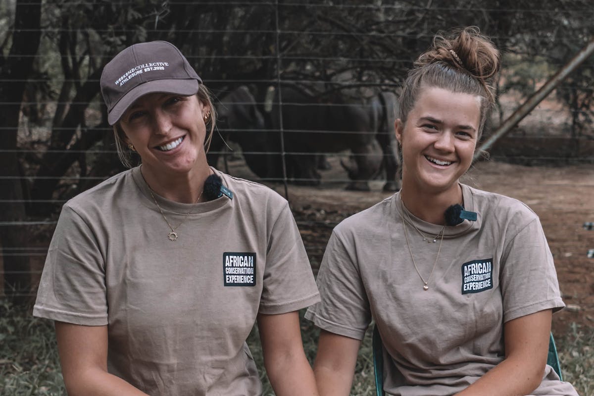 Two girls with anti-poaching dog, at The Rhino Orphanage