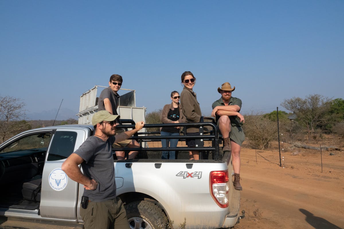 Benedict King: group posing on a vehicle