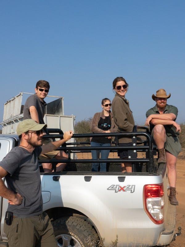 Benedict King: group posing on a vehicle