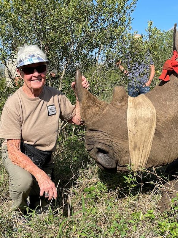 Frances Watson: posing next to a sedated rhino after dehorning