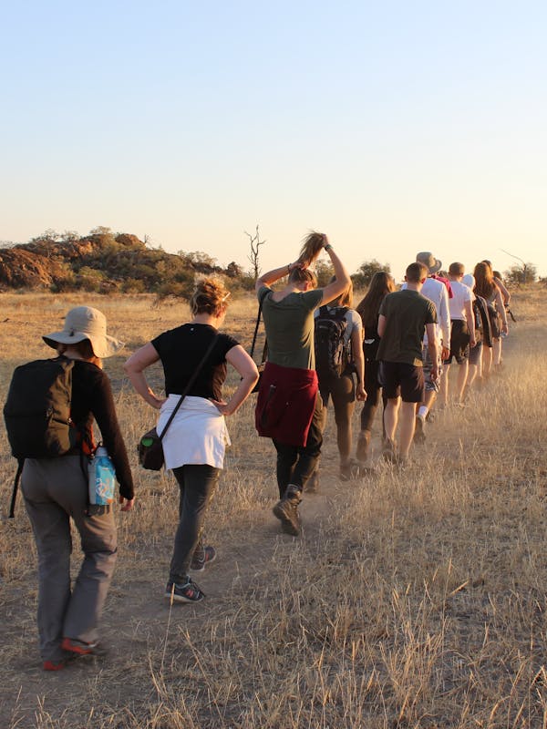 A group of ACE school students hiking through the plains