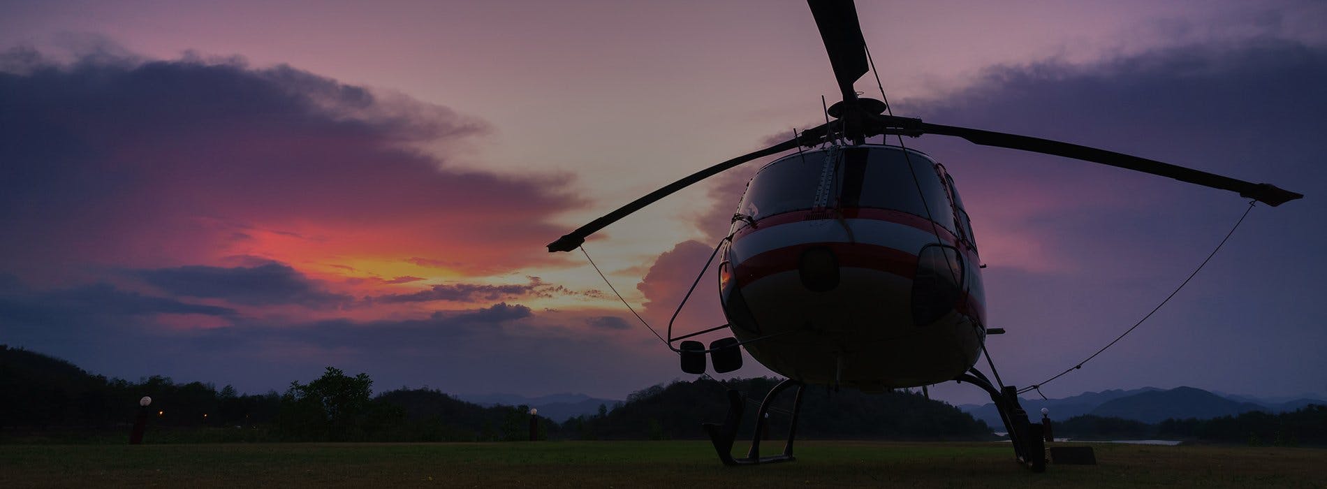 A stationary helicopter at dusk