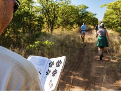 ACE volunteer referring to a tracking guide