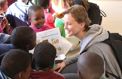 An ACE student teaching primary school age kids in an African School