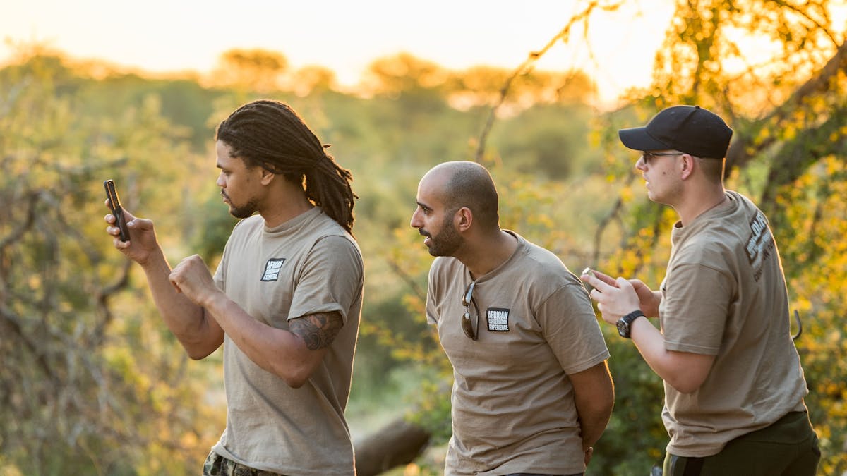Group of male ACE volunteers taking photos in the Okavango