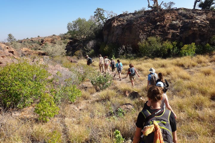 A group of students and teachers hiking through the plains