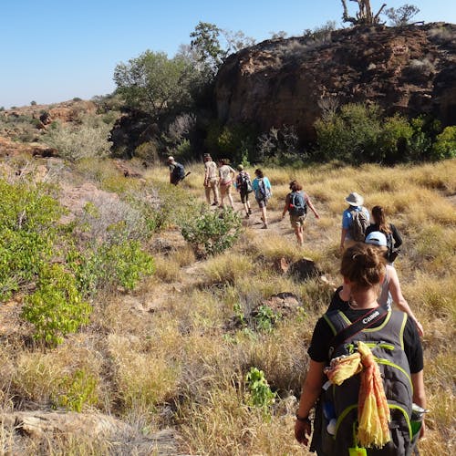 A group of students and teachers hiking through the plains