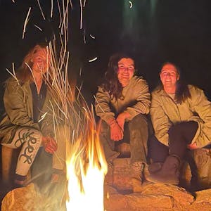 Vet student group relaxing by the campfire