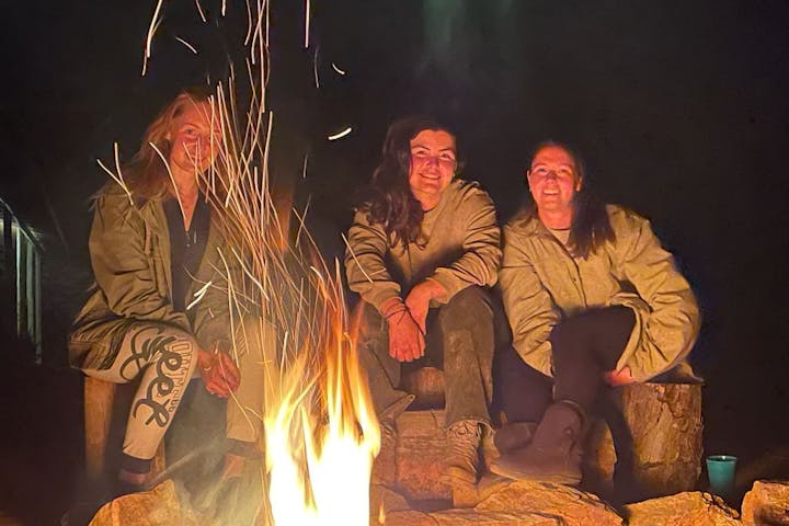 Vet student group relaxing by the campfire