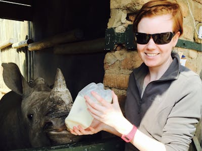 Jessica Gunn bottle feeding a rhino