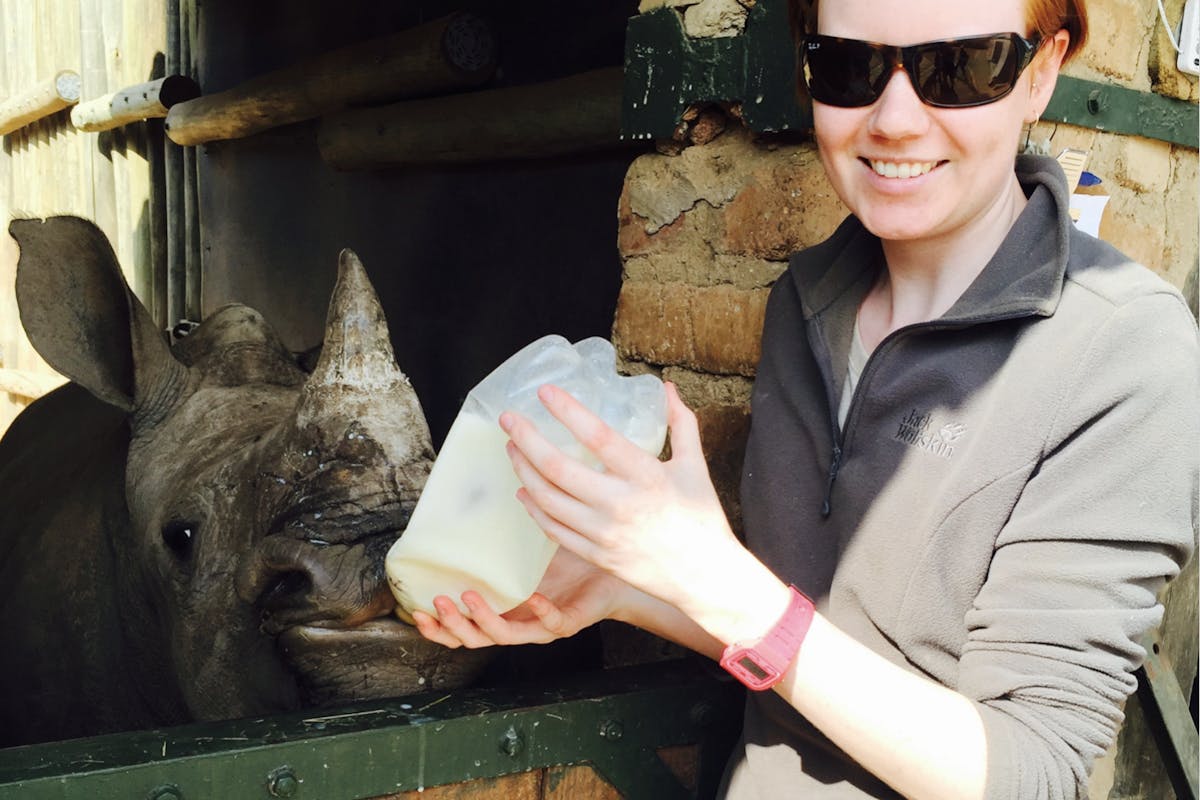 Jessica Gunn bottle feeding a rhino