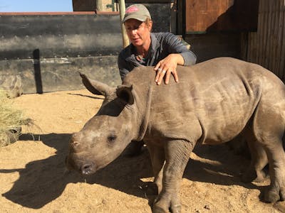 Diana DeBlanc with a rhino at Care for Wild