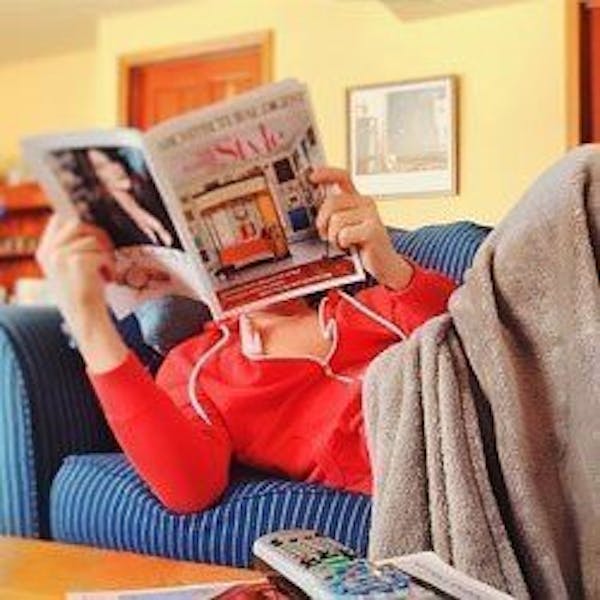 Reading a magazine on the couch