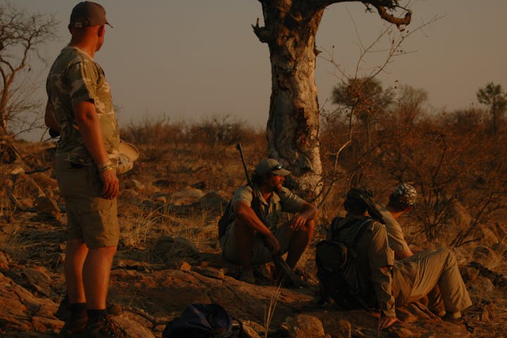 Group of ACE volunteers and game rangers relaxing in the bush