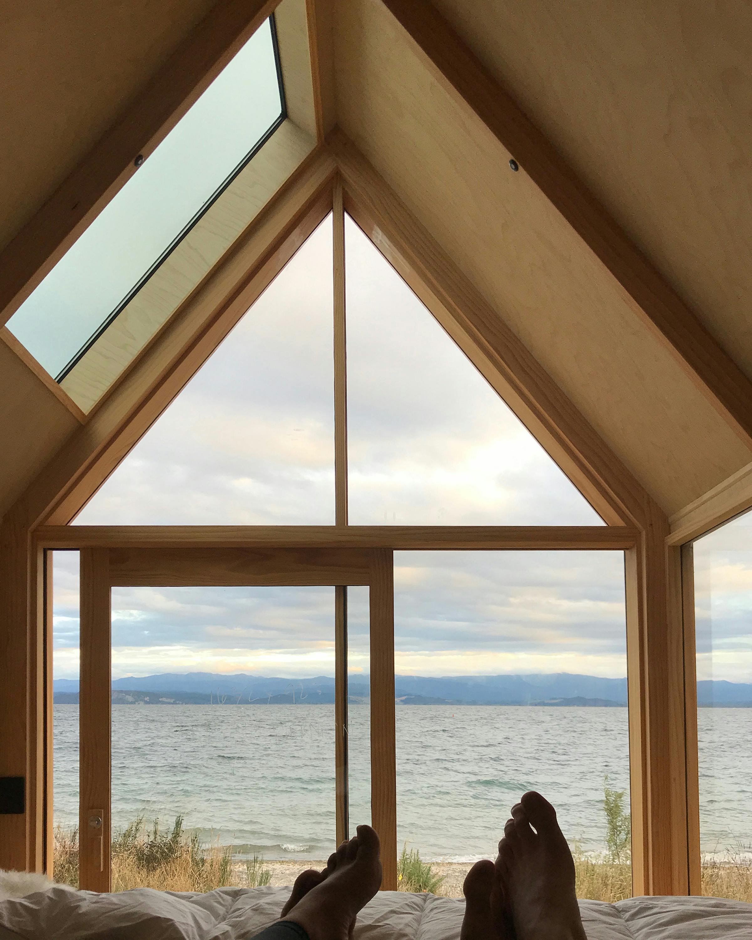 The trailer house parked with a waterfront view.