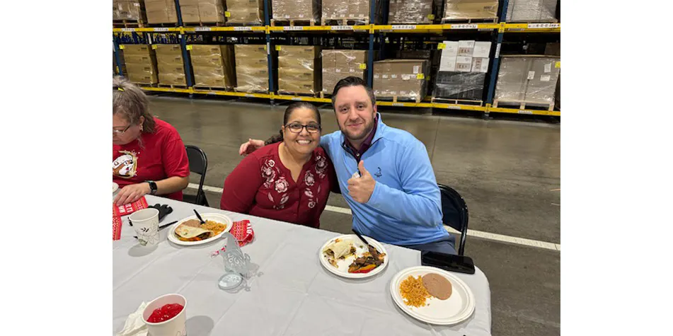 Two employees enjoying holiday dinner at The Container Store's distribution center