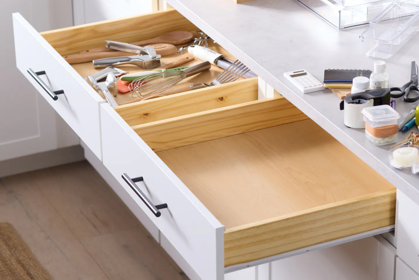 One cluttered utensil drawer and one empty junk drawer