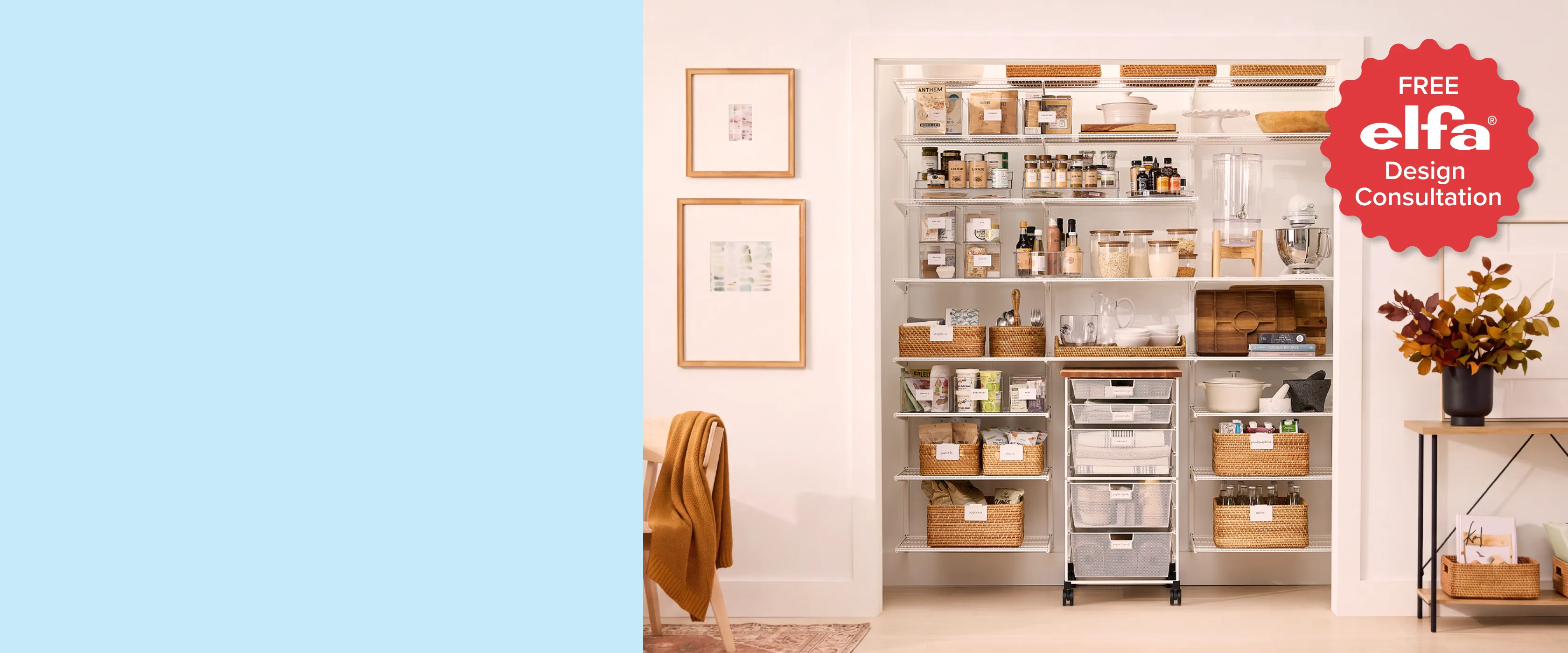 Bright pantry nook outfitted with a white Elfa Classic shelving system holding labeled food containers, spice jars, woven baskets, glassware, and a rolling mesh drawer unit, beside framed art and a chair with a mustard throw. A red badge reads: Free Elfa Design Consultation.