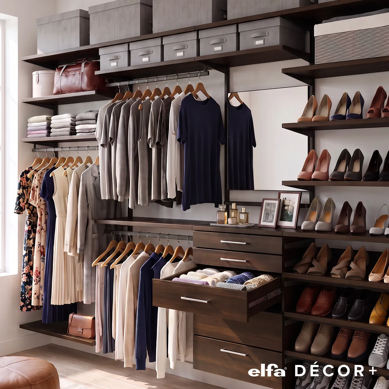 An Elfa Decor+ walk-in closet in Stained Birch displaying hanging clothes, drawers, gray storage boxes, and rows of shoes.