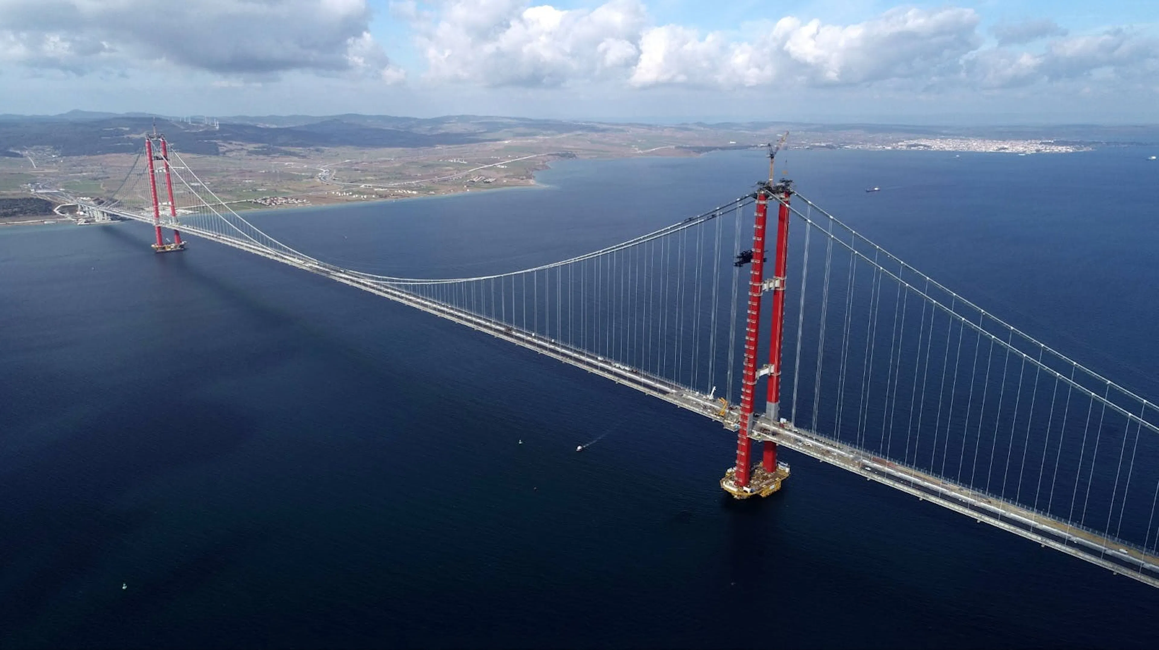 Aerial photograph of the 1915 Çanakkale Bridge, its red towers carrying a suspension span across the Dardanelles