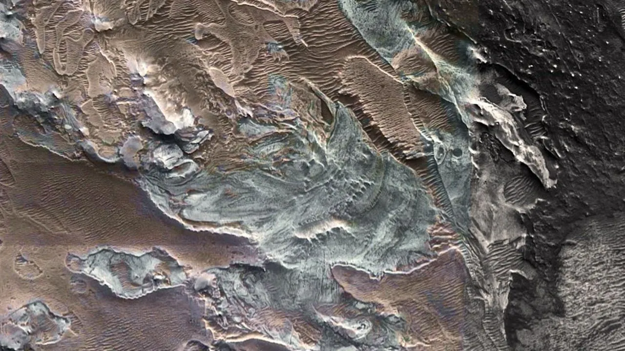 Orbital image of glacier-like flow features in a Martian canyon, pale layered deposits between dark ridges