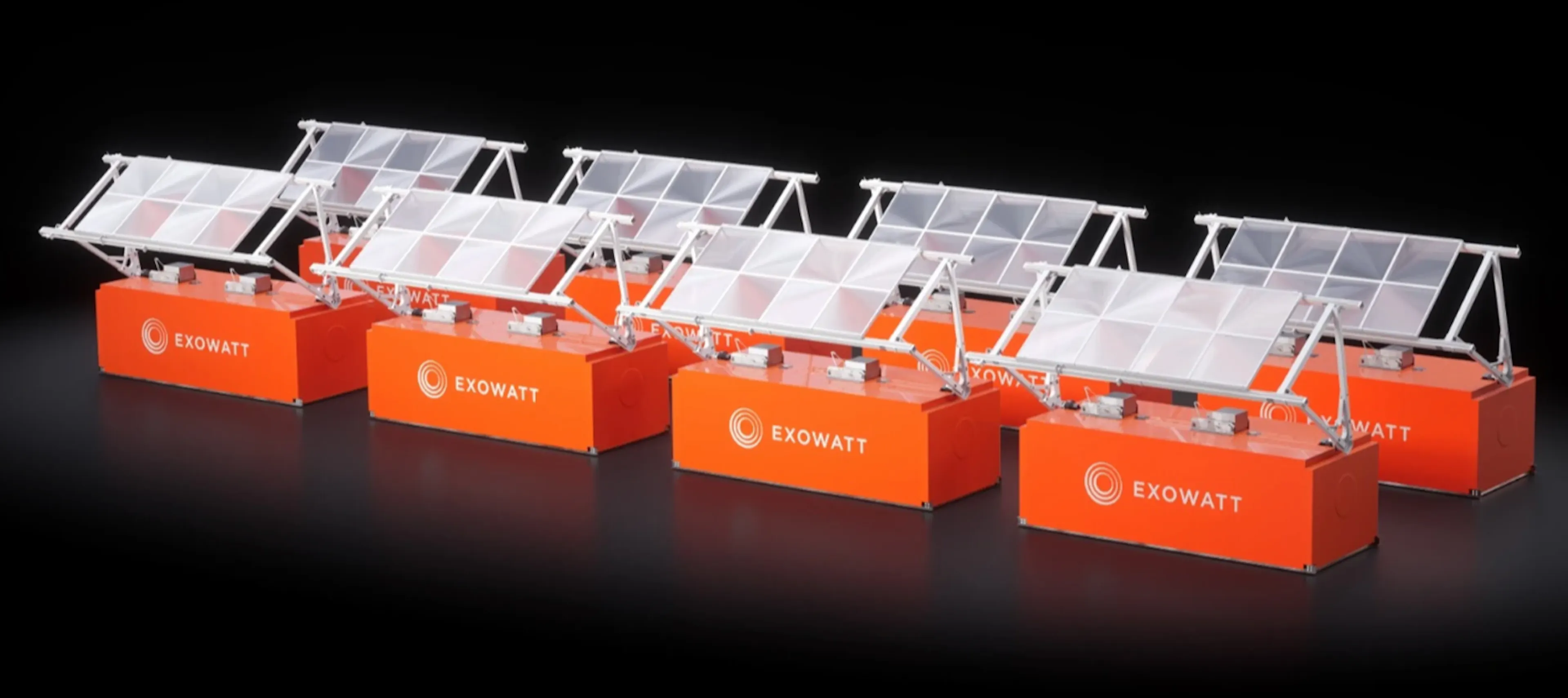 A row of Exowatt P3 modules, each an orange container base topped by a tilted array of Fresnel lenses