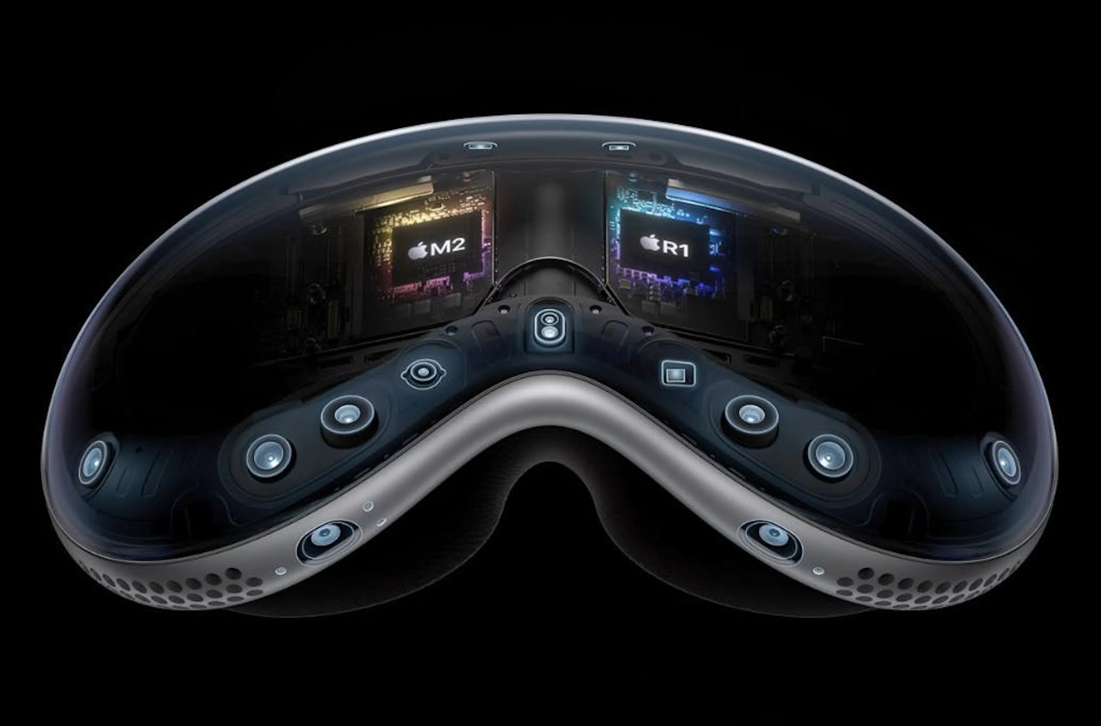 Product image of the Apple Vision Pro headset, its sensor array and M2 and R1 chips highlighted