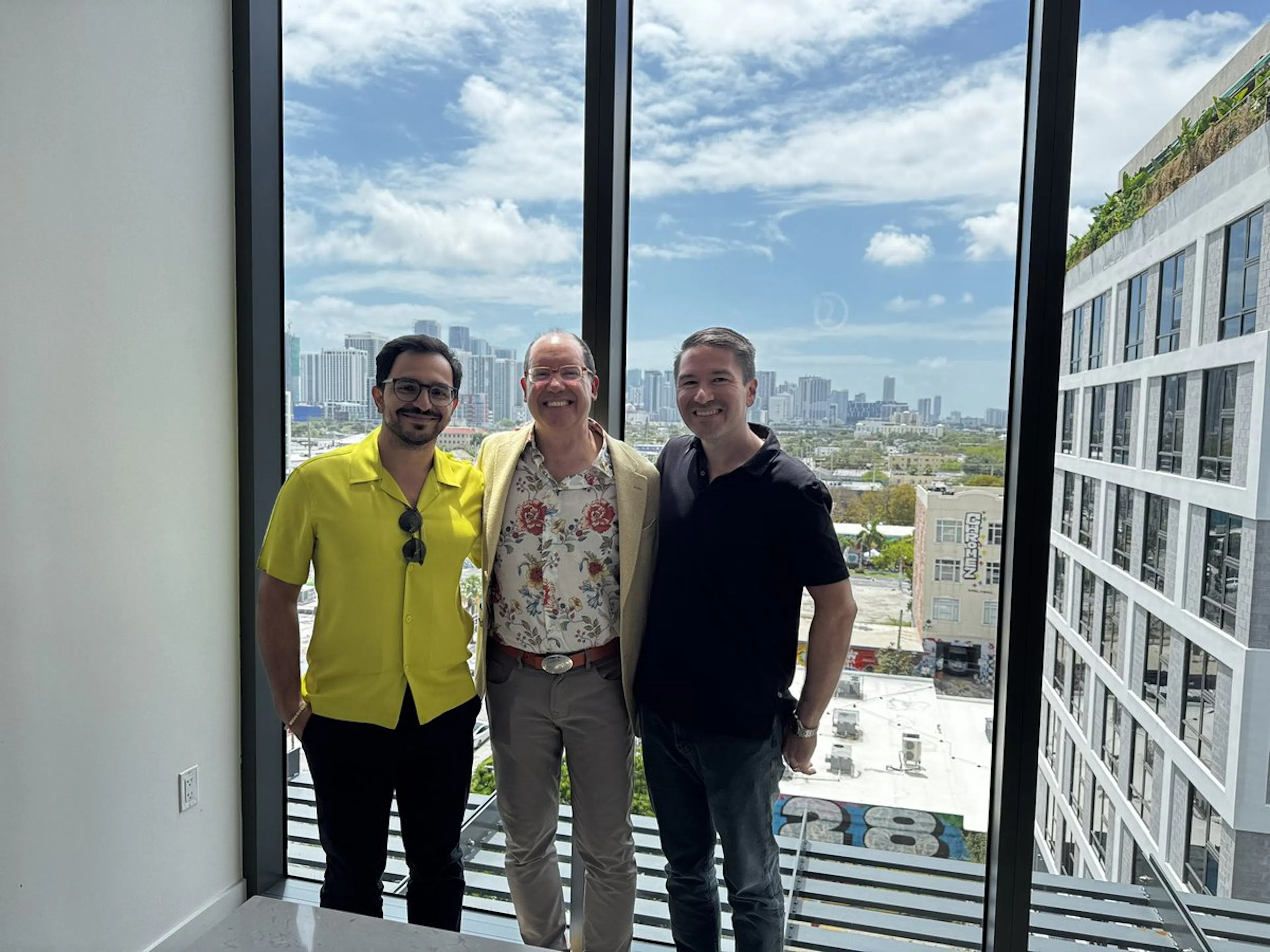 Three people standing in front of a window overlooking the Miami skyline, in a photo shared by Felicis founder Aydin Senkut
