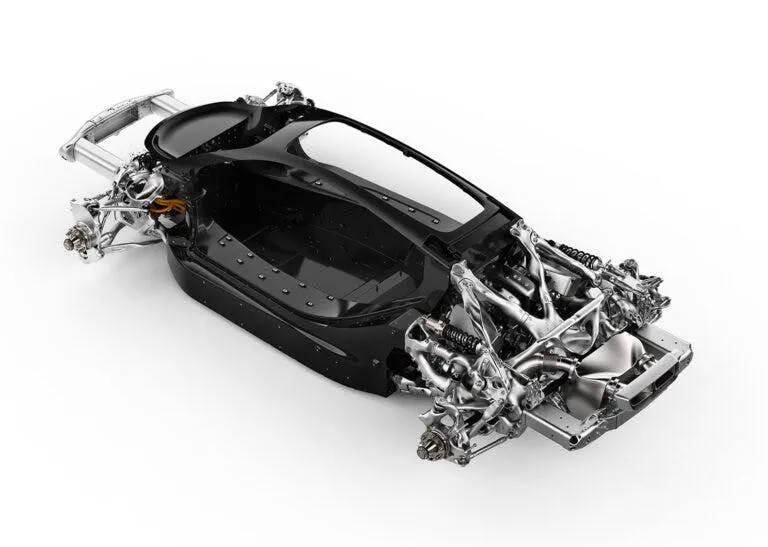 Photograph of a hypercar chassis with 3D-printed suspension and structural components in polished metal