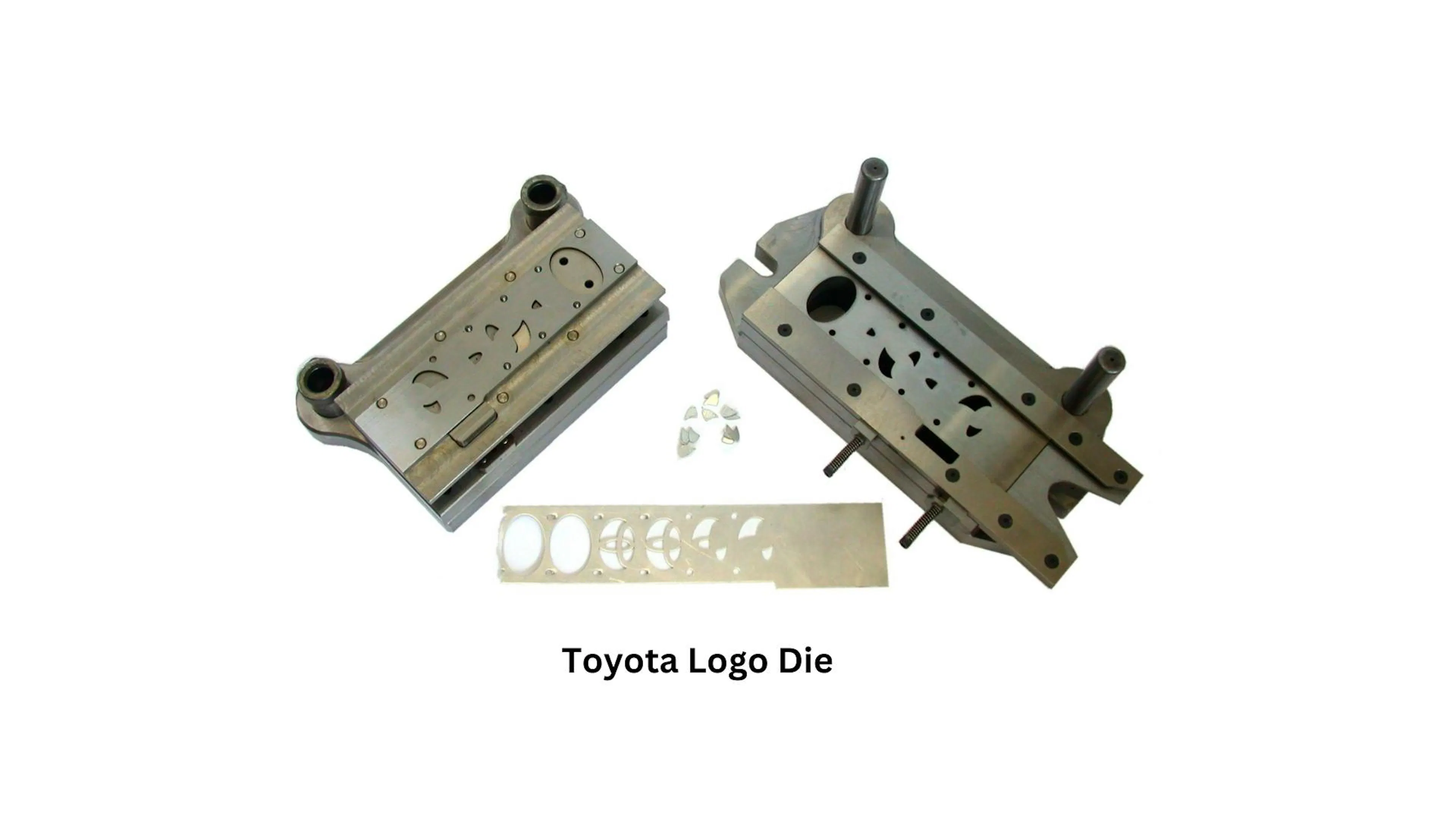 Photograph of a two-part Toyota logo die with the stamped metal badge it produces