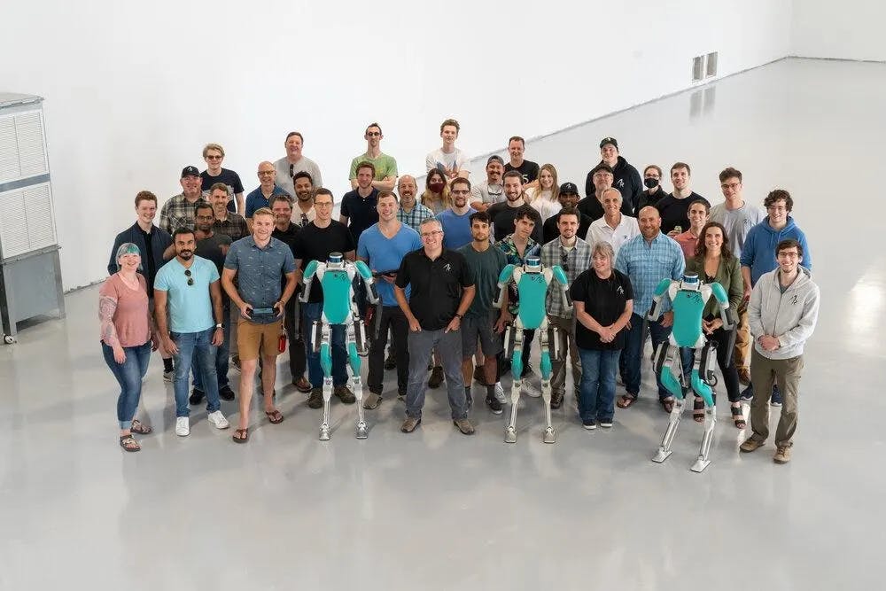 Agility Robotics’ Damion Shelton and his team, along with three Digit robots.