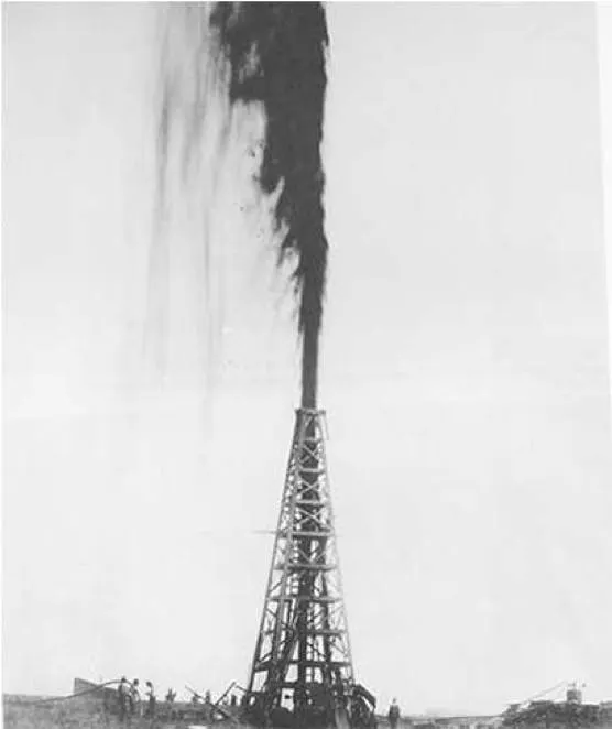 Black-and-white photograph of the Spindletop gusher, a column of oil blowing high above a wooden derrick