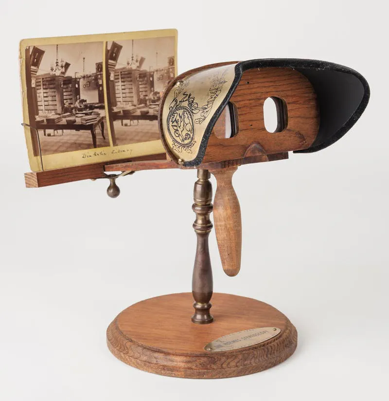 Photograph of an antique handheld stereoscope holding a stereo card