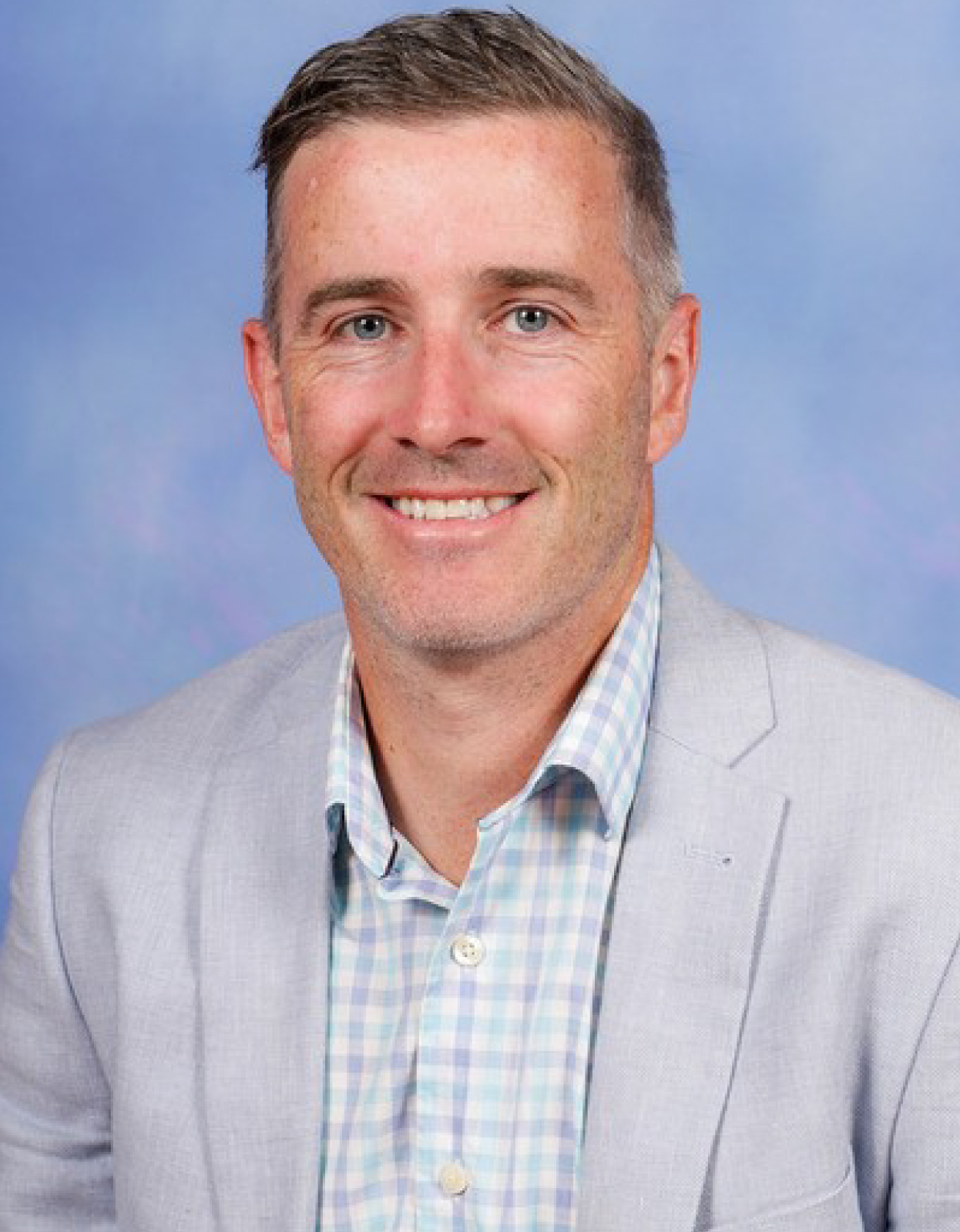 Steven, an Australian teacher, seen smiling and looking towards the camera