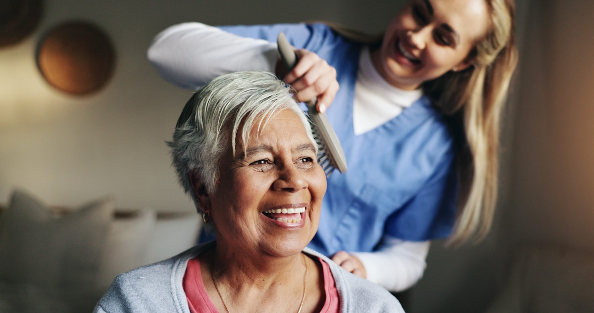Nurse brushing patient's hair