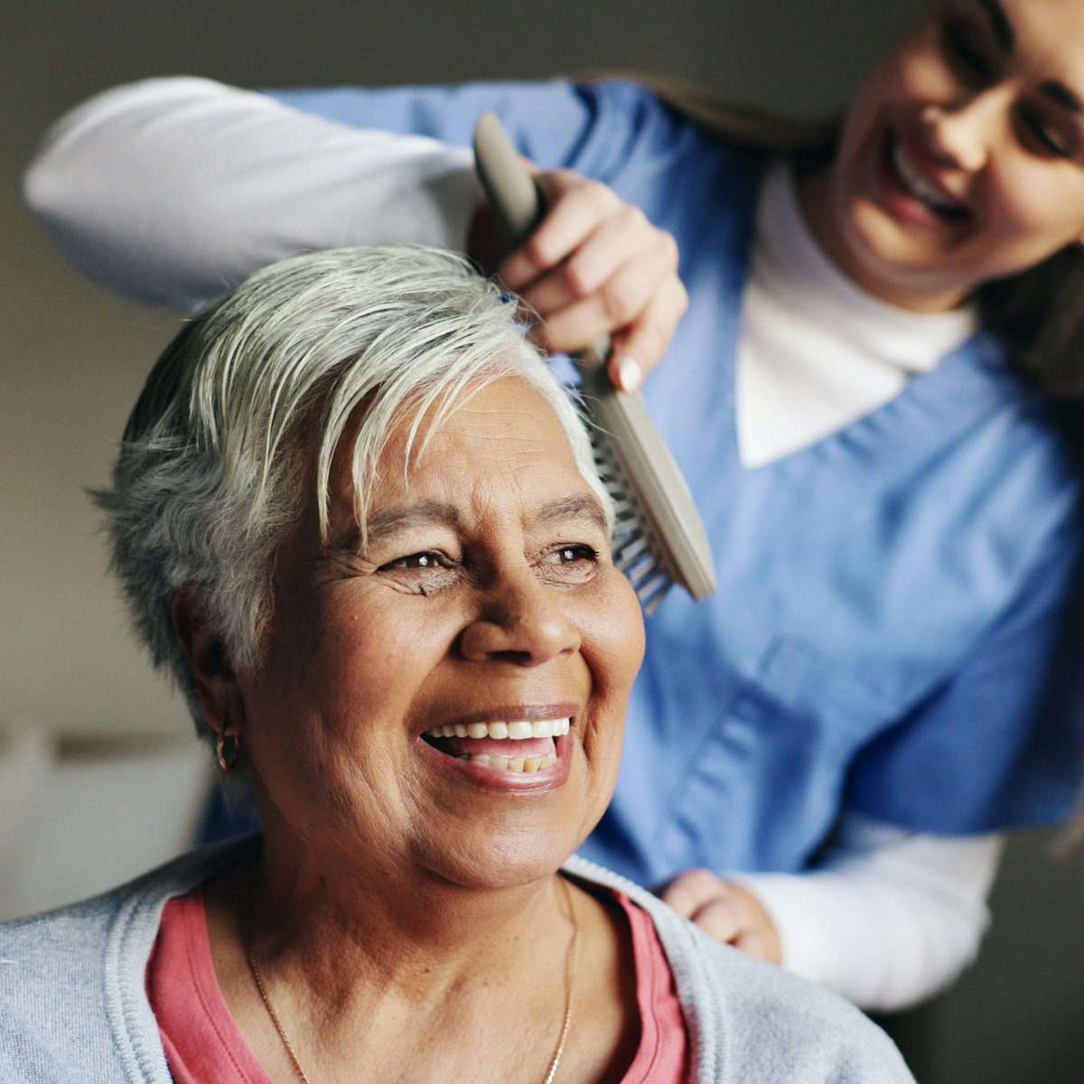 Nurse brushing patient's hair