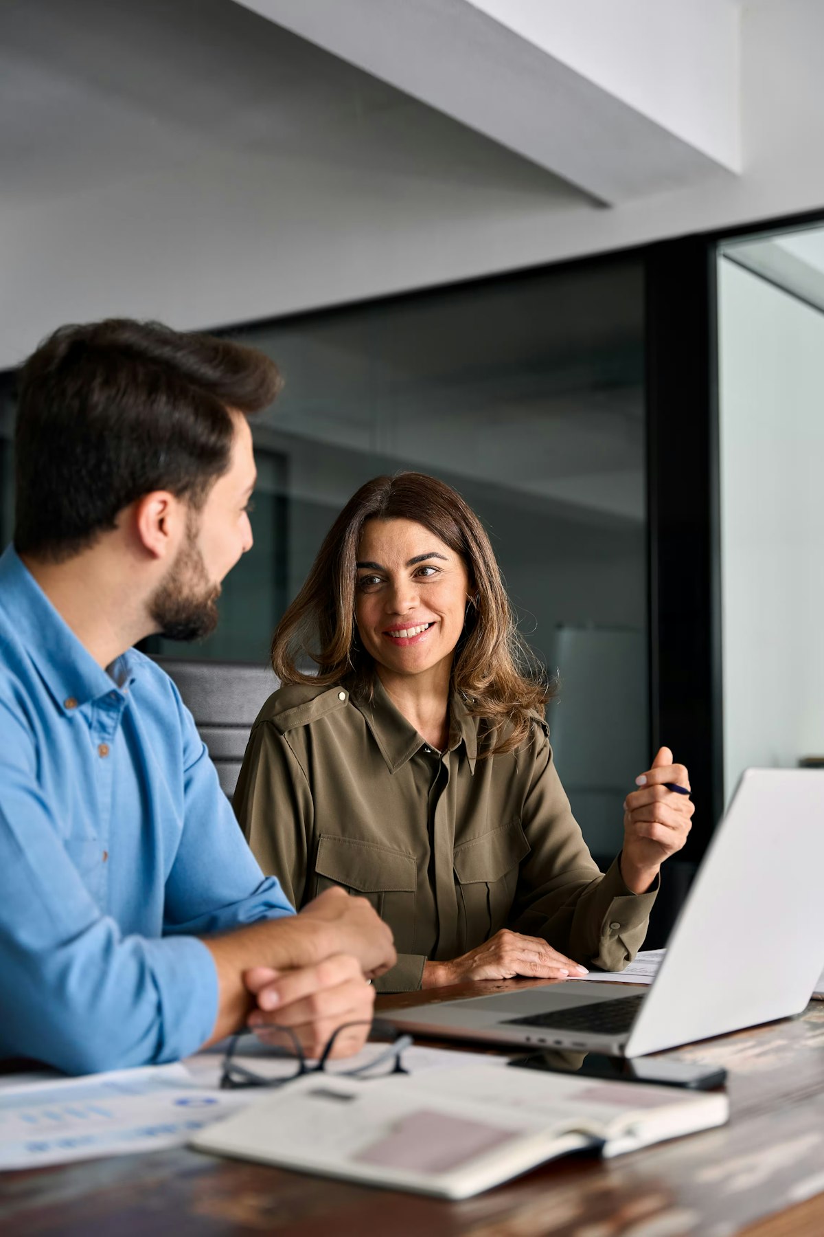 Man and woman working at laptop together