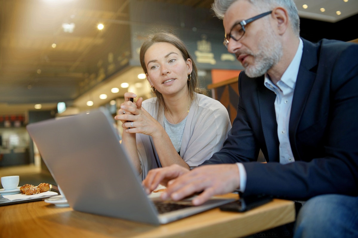 two people with laptop planning