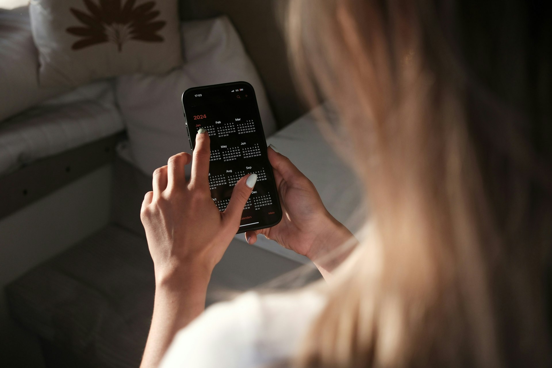 woman looking at calendar checking 4 on 4 off shift pattern on her phone