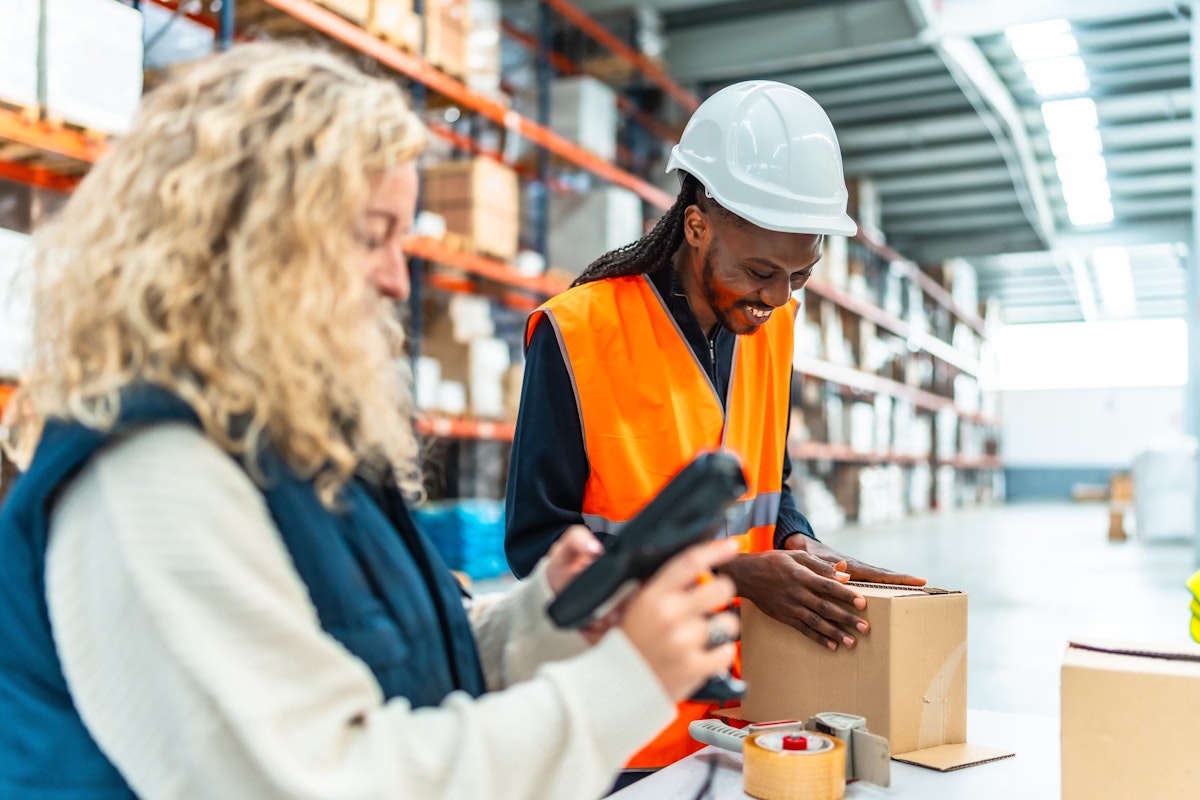 two people working together in a warehouse