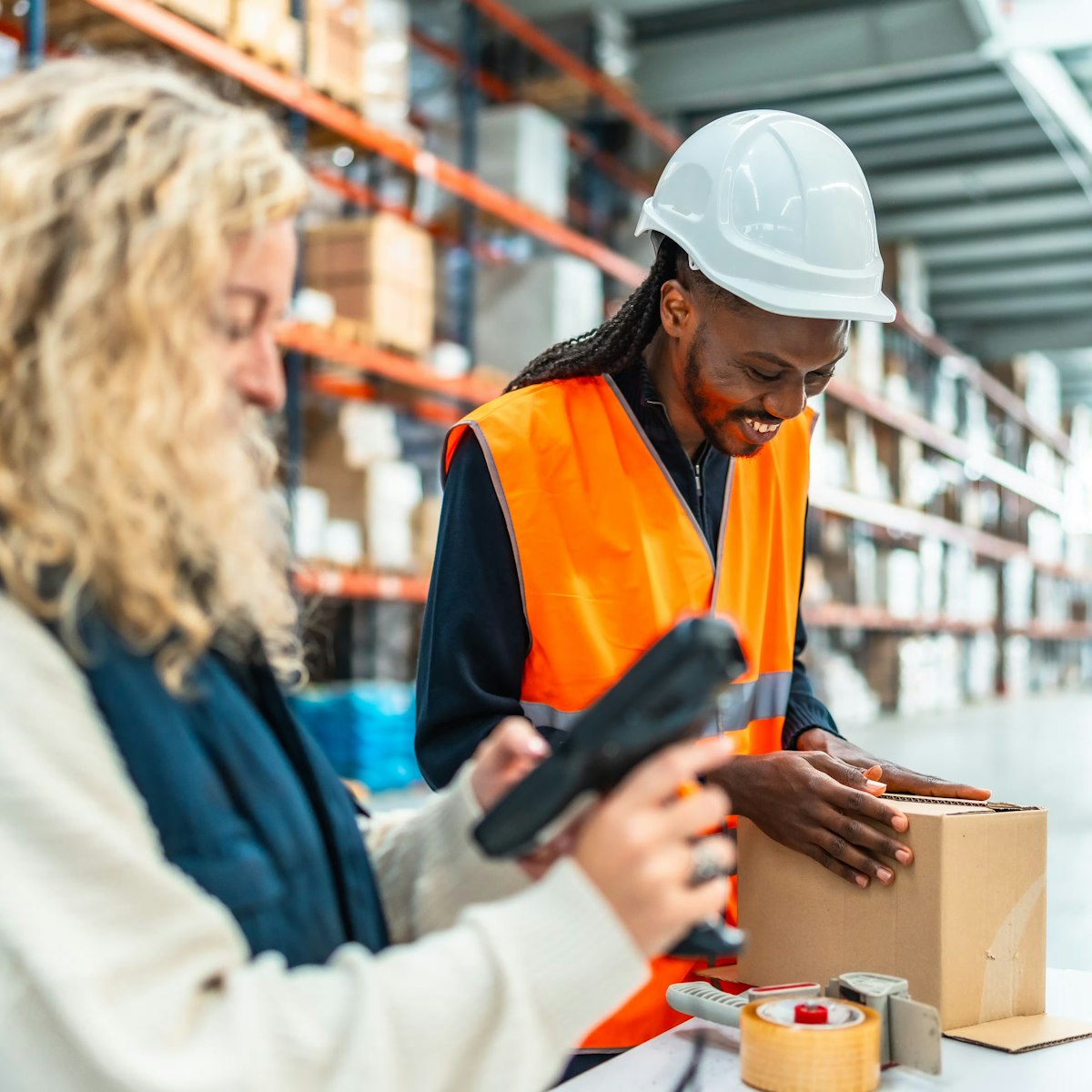 two people working together in a warehouse