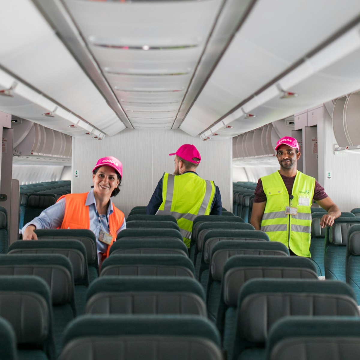 people cleaning inside an airplane