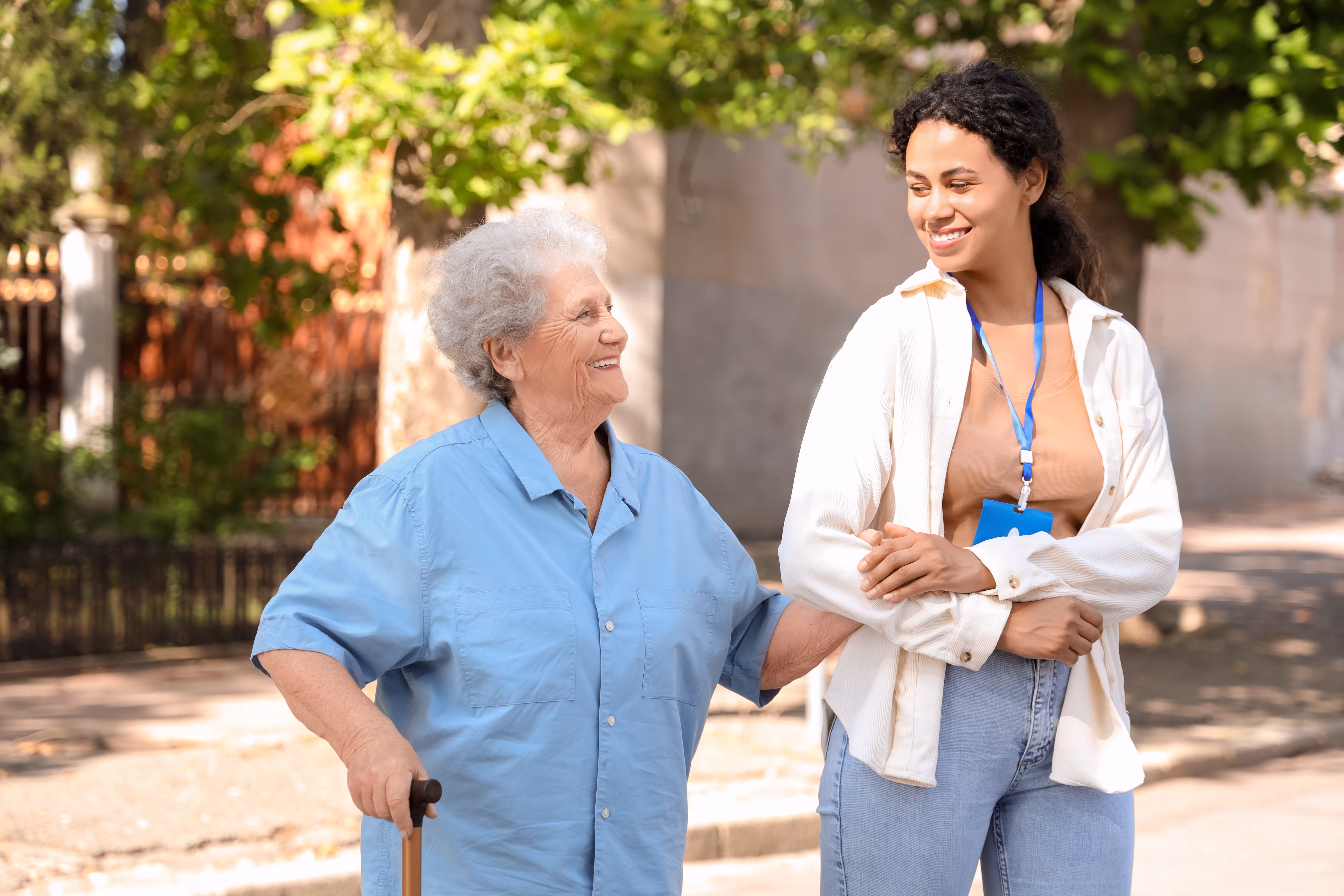 nurse in plain clothes walking with elderly woman