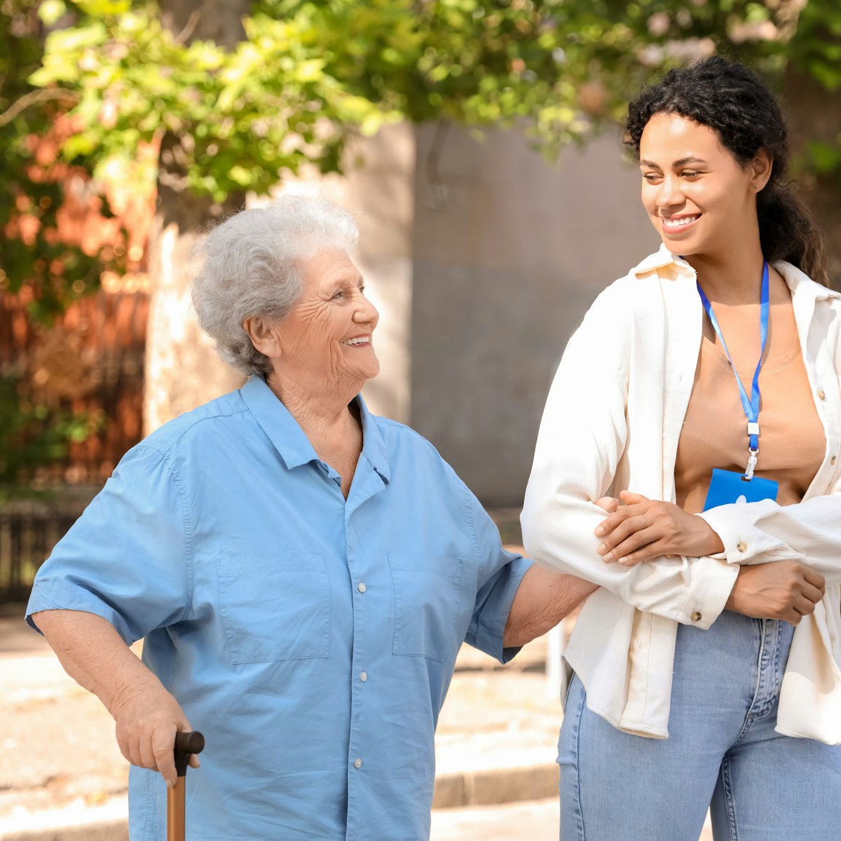 nurse in plain clothes walking with elderly woman